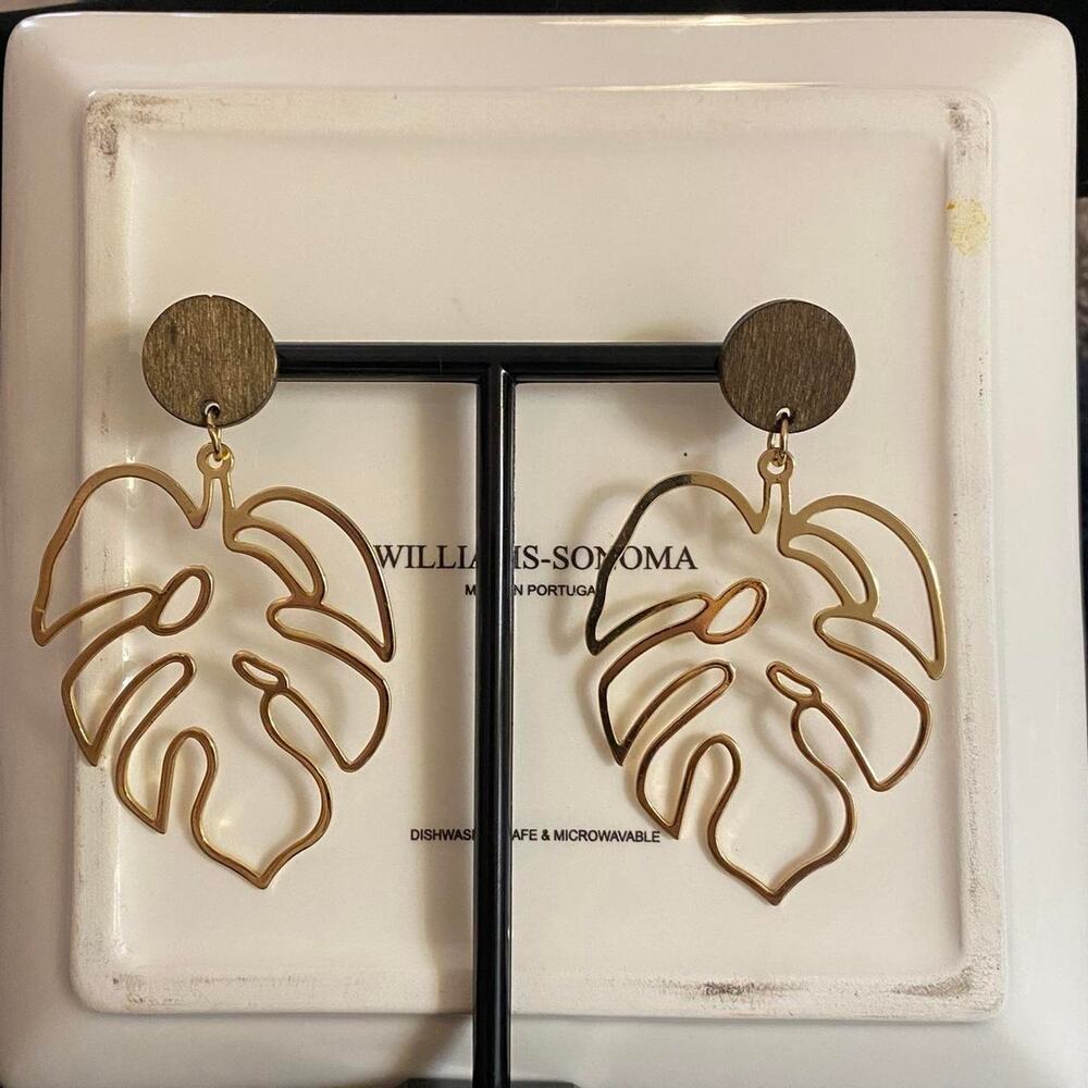 Gold leaf tropical earrings with round wood base.